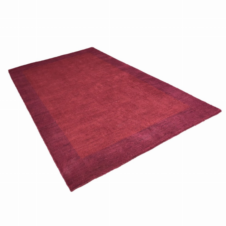 Burgundy rectangular area rug with low pile and subtle tonal texture