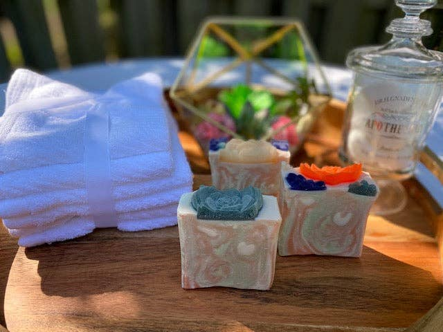 Pastel square succulent soap boxes with teal and blue bars plus an orange soap top