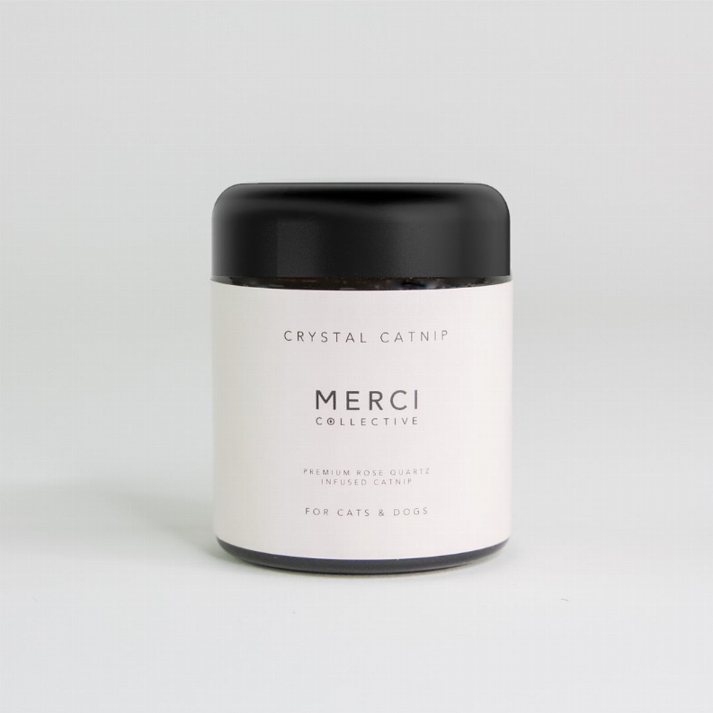 White catnip jar with black lid; label shows Crystal Catnip, Merci Collective.