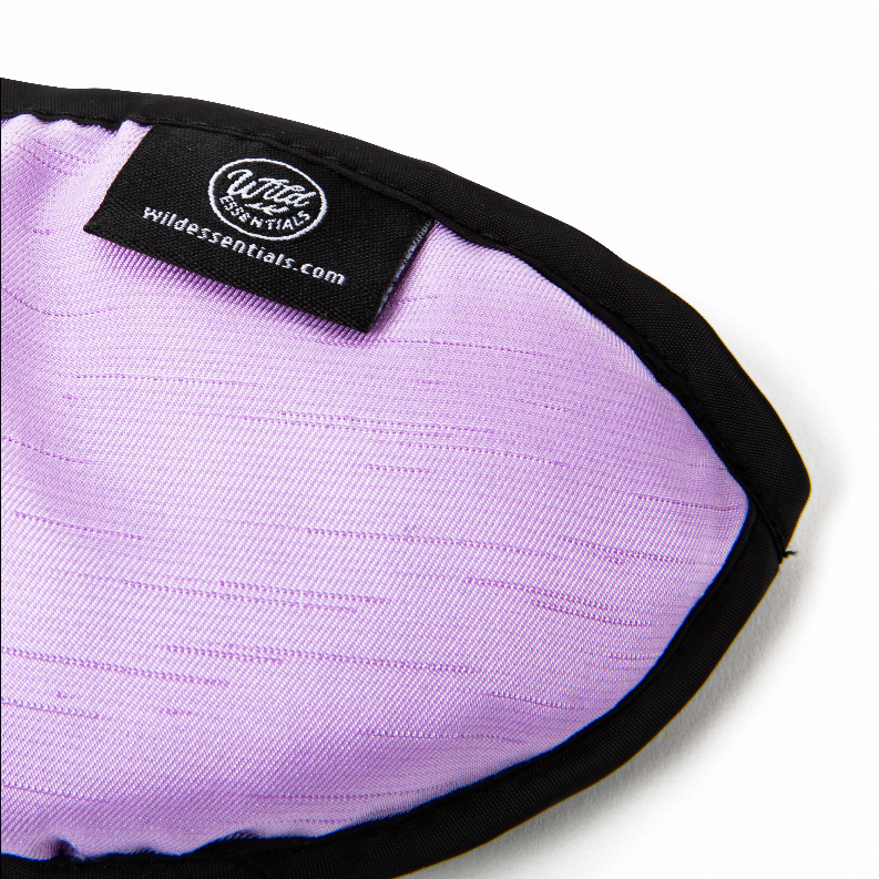 Lavender sleep mask with black label patch and quilted fabric texture