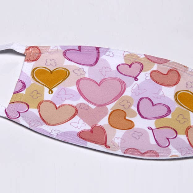 Pastel hearts flat face mask with multicolor heart print on light purple fabric