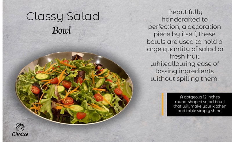 Gold-rimmed salad bowl filled with greens, tomatoes, and sliced vegetables