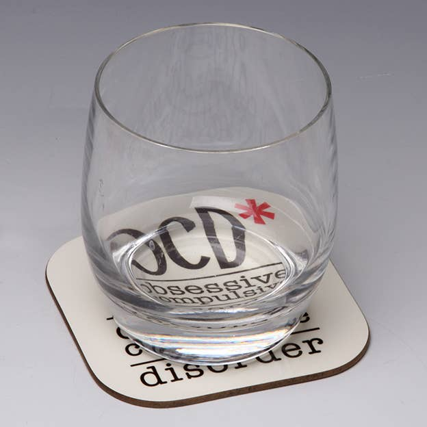 OCD obsessive coffee disorder coaster with black lettering and red asterisk accents