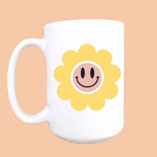 Ceramic coffee mug with happy face daisy graphic, yellow flower on white