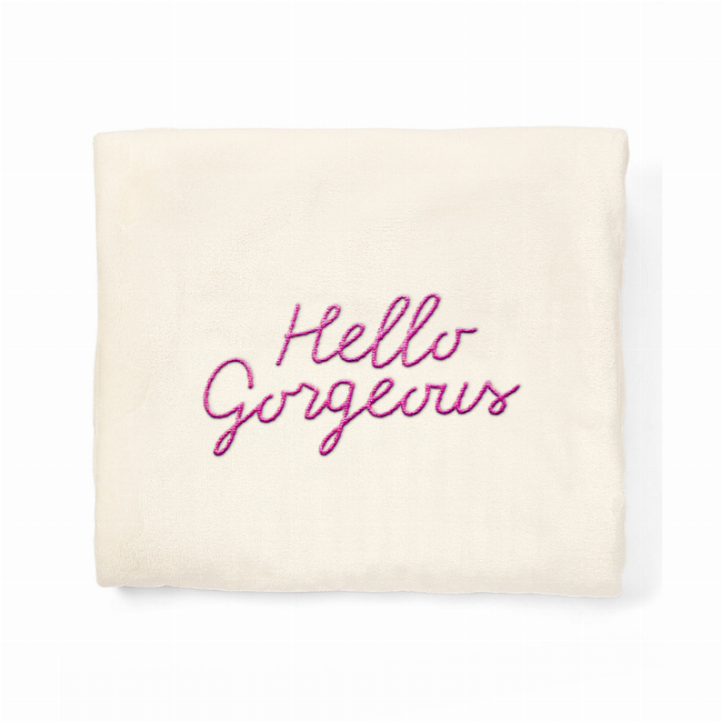 Cream plush fleece nap blanket with embroidered “Hello Gorgeous” text