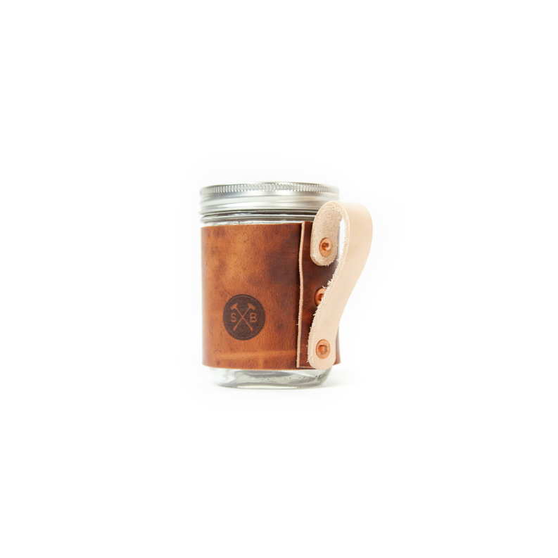 Rustic coffee mug jar with metal lid and brown side SxB logo