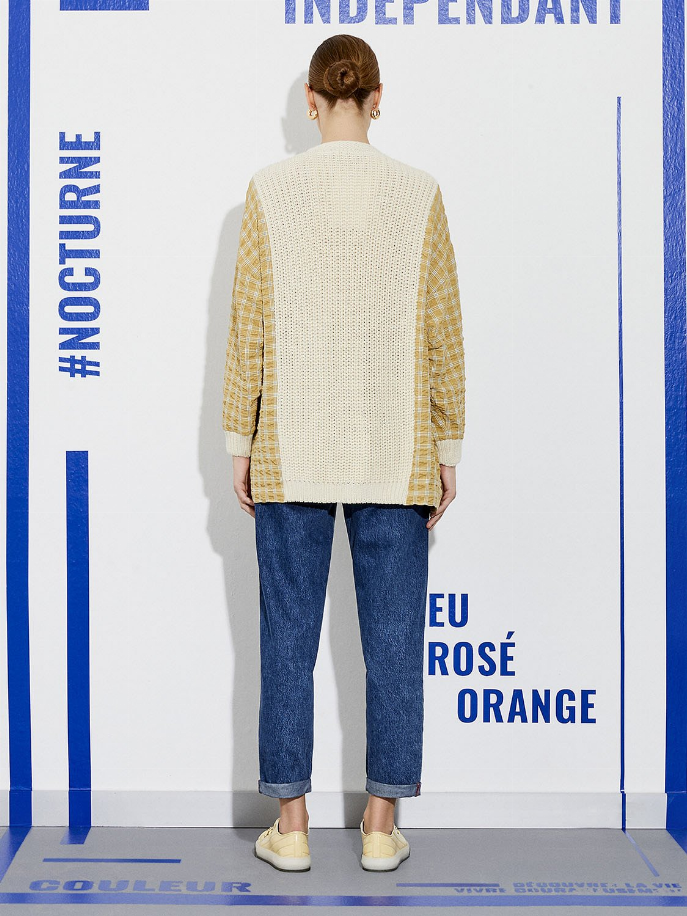 Knit cardigan with cream body and yellow plaid sleeves, ribbed cuffs and hem