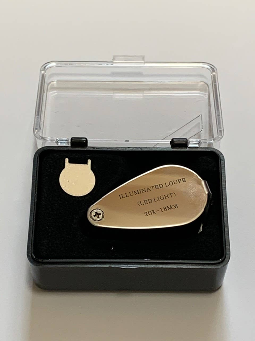 Gold LED jeweler loupe head with magnifier lens, plus black storage case