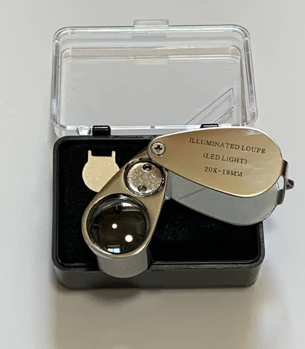 Gold LED illuminated jeweler loupe with glass lens in black storage case