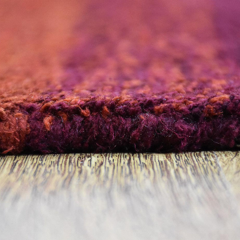 Hand-knotted silk mix rug close-up, deep burgundy and purple fiber pile