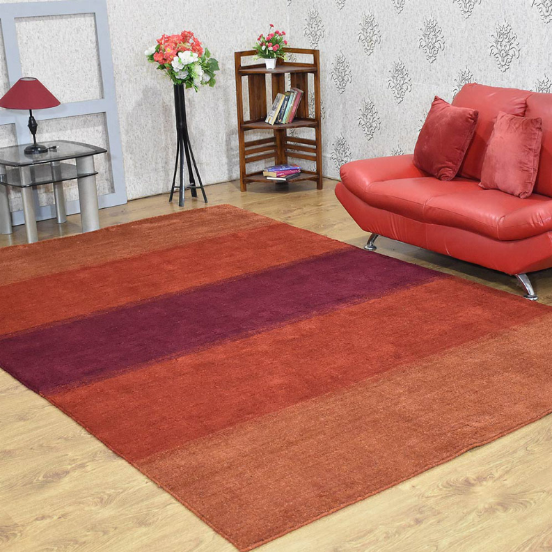Contemporary area rug with rust-red field and wide muted border