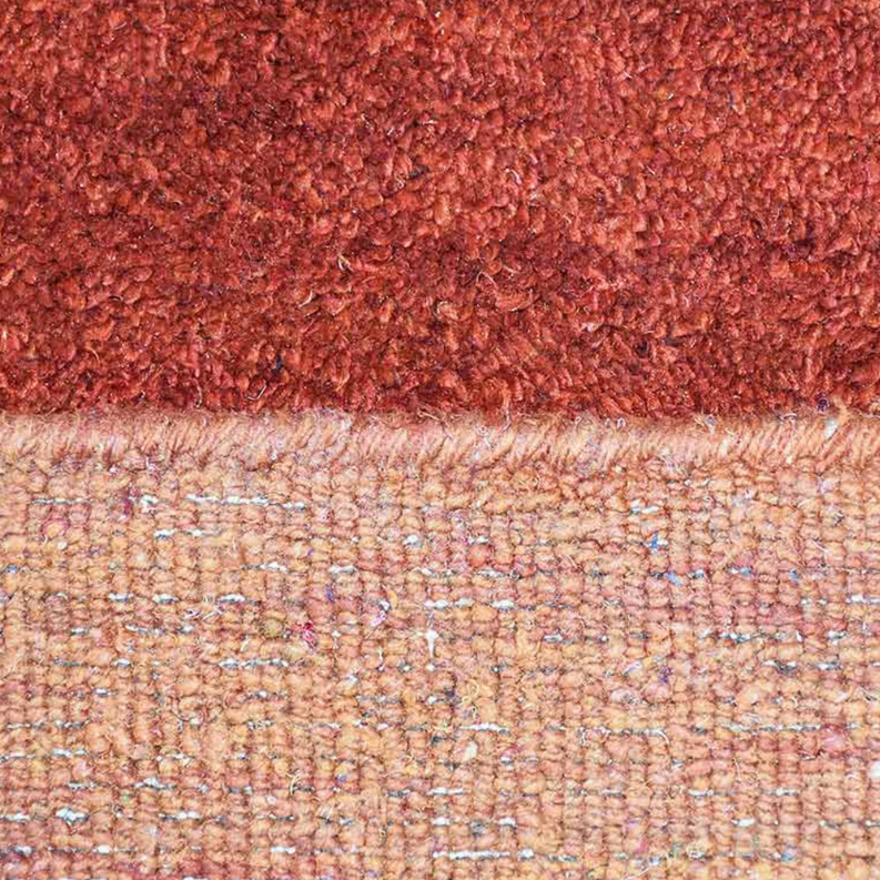Hand-knotted silk mix rug close-up, rust-red pile with cream flecked backing