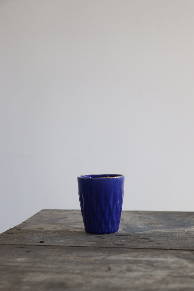 Handmade cobalt blue ceramic coffee cup, cylindrical with textured rim