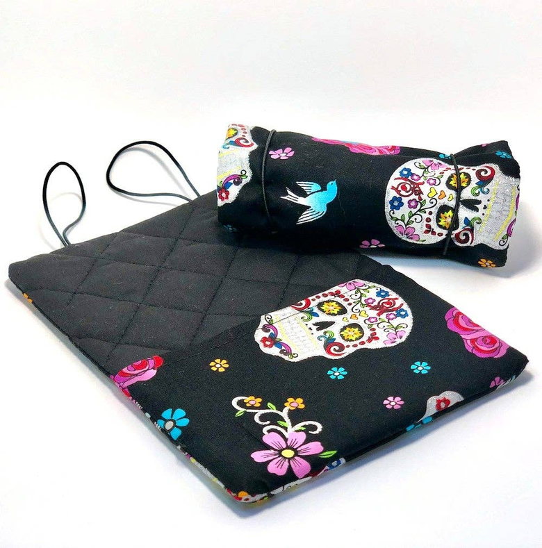 Quilted black drawstring bag with sugar skull, floral, and bird motifs.