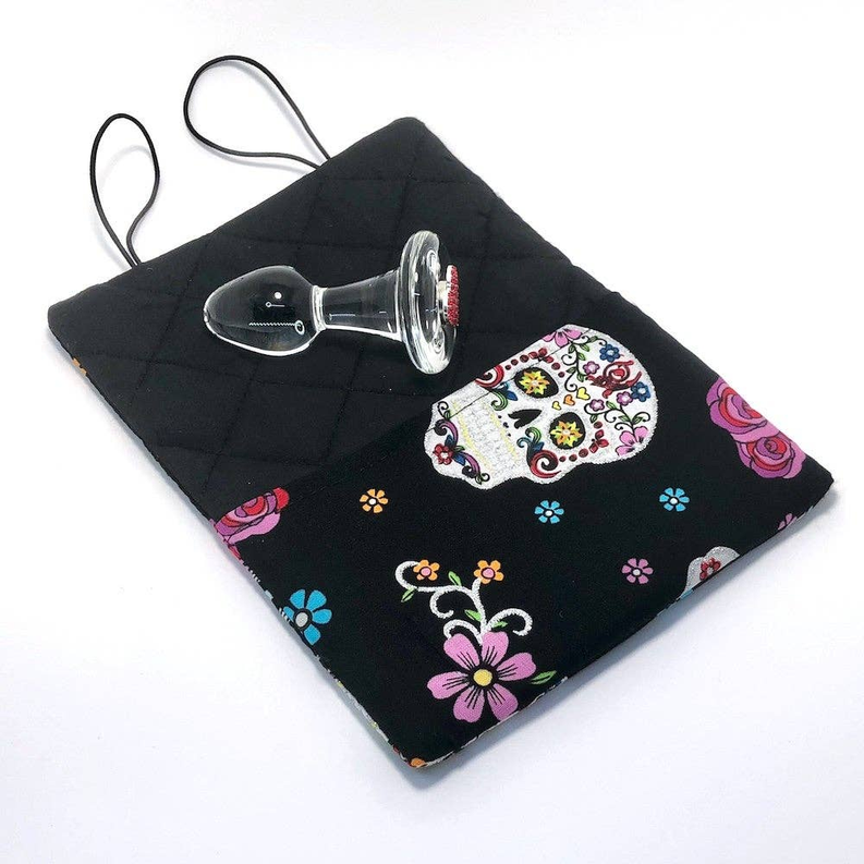Quilted black drawstring bag with sugar skull print and colorful floral details.