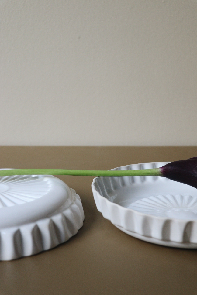 Handmade ceramic dinner plates, white, two plates showing ridged rim and embossed center