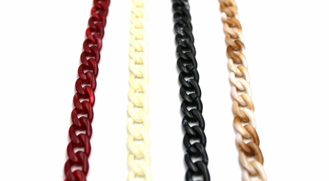 Eyeglasses holder chain close-up showing red, cream, black, and tan linked strands