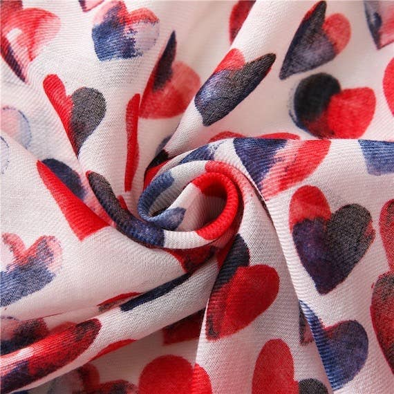 Lightweight voile scarf featuring red, navy, and black hearts on a white background