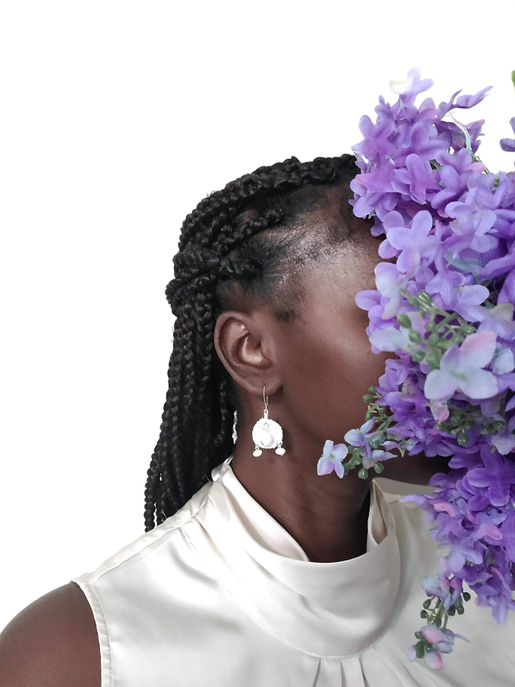 White stone drop earrings worn on model, dangling from silver-tone hooks