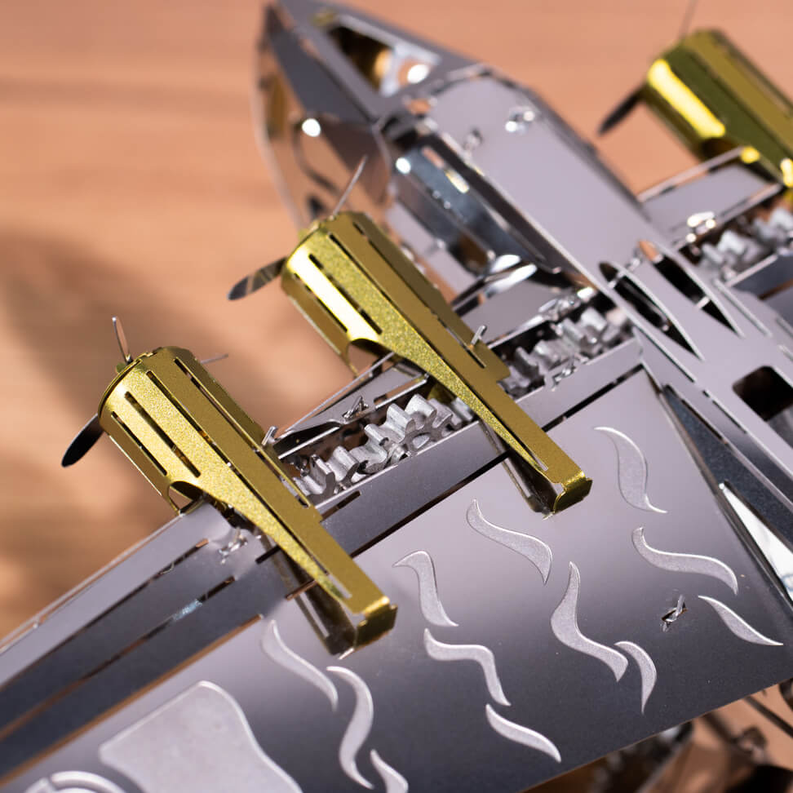 Dark gray and gold mechanical aircraft wing detail with flame cutouts