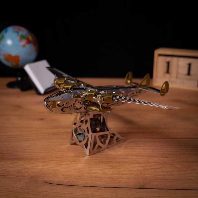 Gold and dark gray mechanical aircraft model with landing gear, side view