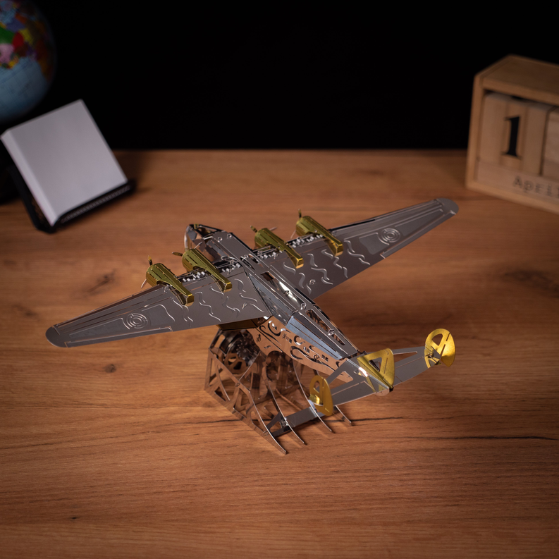 Angled mechanical metal aircraft model with gold accents and wing details