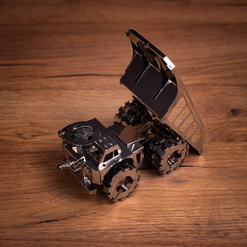Metal mining truck model kit, angled view of tracks, frame, and lifting bed