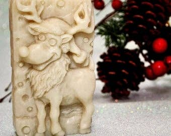 Ivory reindeer-shaped carved soap bar with textured holiday design.