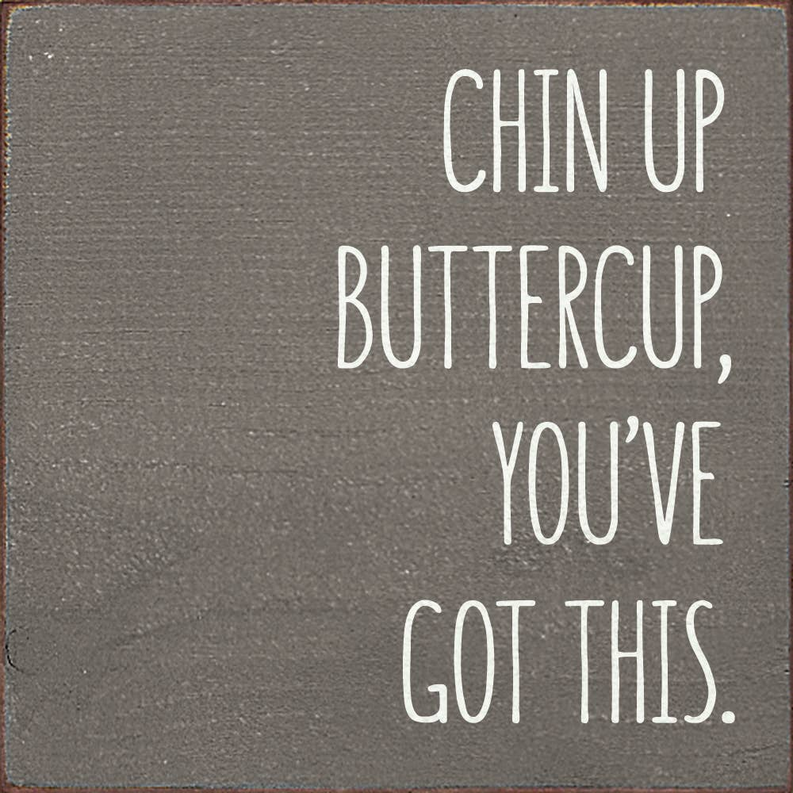 Distressed wood wall sign with white text: CHIN UP BUTTERCUP, YOU'VE GOT THIS.