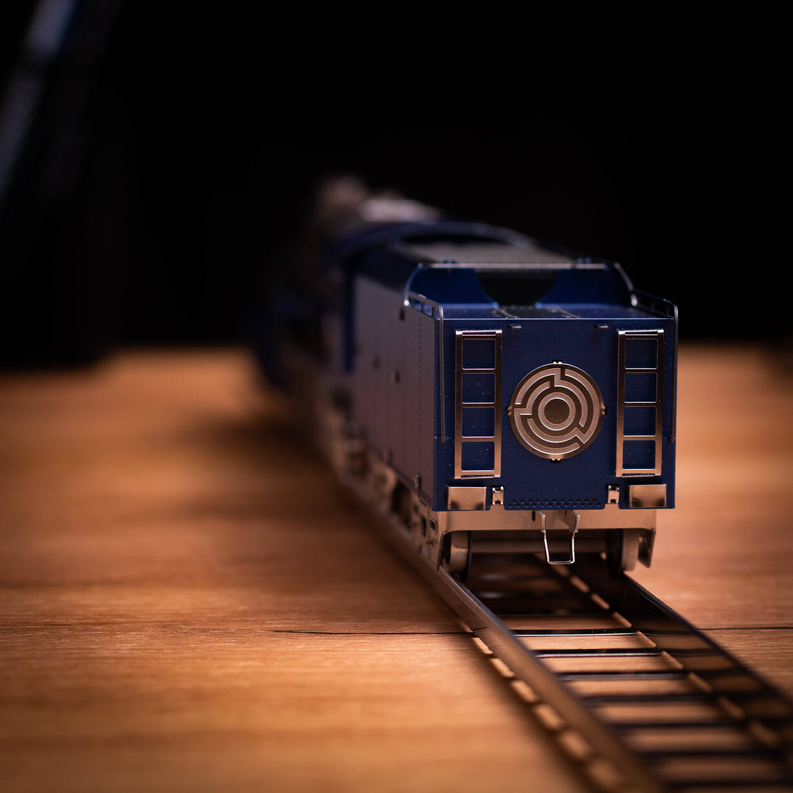 Blue and silver steam locomotive model front with circular emblem detail