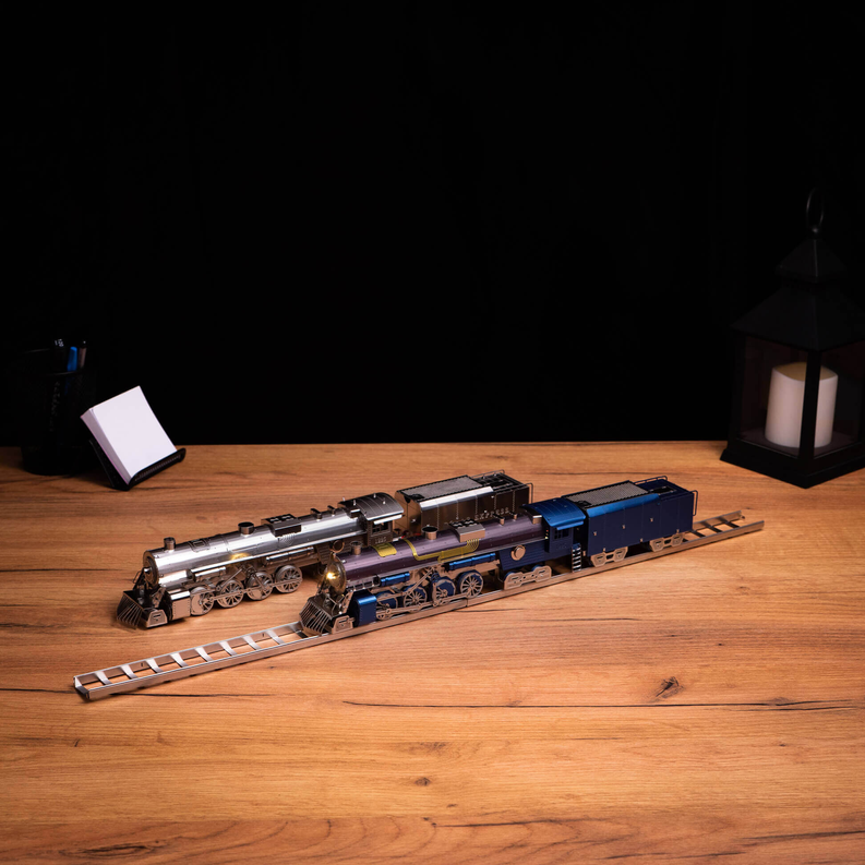Blue, gold, and silver steam locomotive model with front and tender on display