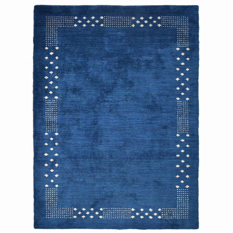 Blue area rug with white geometric border accents and centered solid design