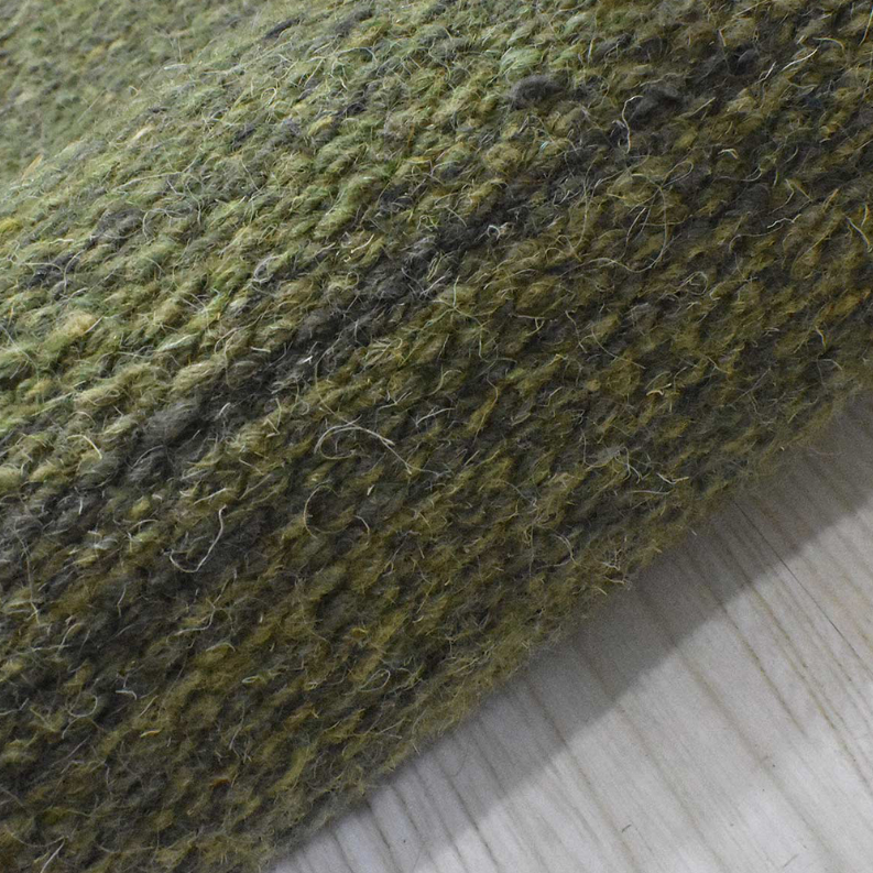 Olive green wool area rug with dense flat weave texture and subtle tonal shading