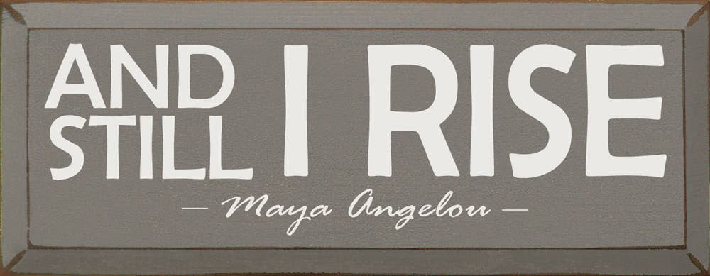 Wood sign: 'AND STILL I RISE' and 'Maya Angelou' script
