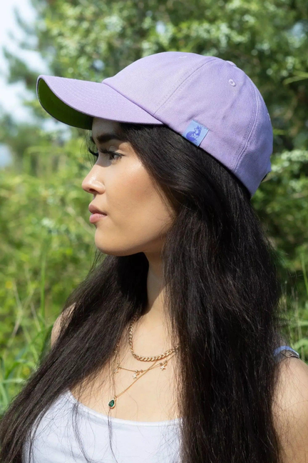 Lavender relaxed baseball cap with green underside and side logo patch