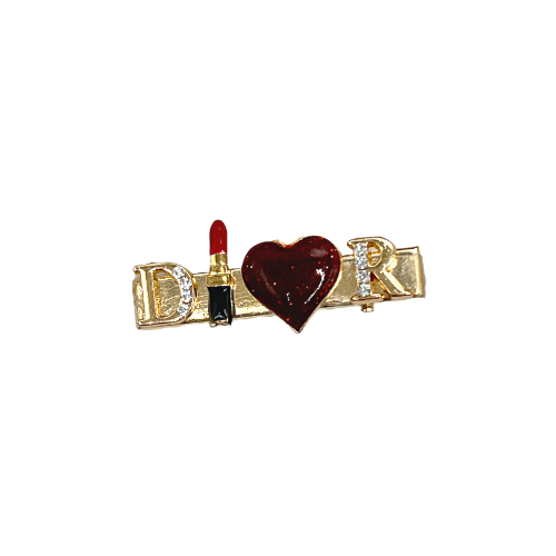 Gold-tone dog hair clip with red heart and lettered charm details