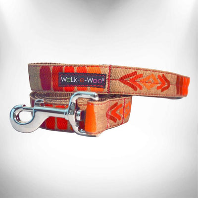 Tribal dog lead with metal clip, orange patterned webbing and Wolk-e-Woo tag