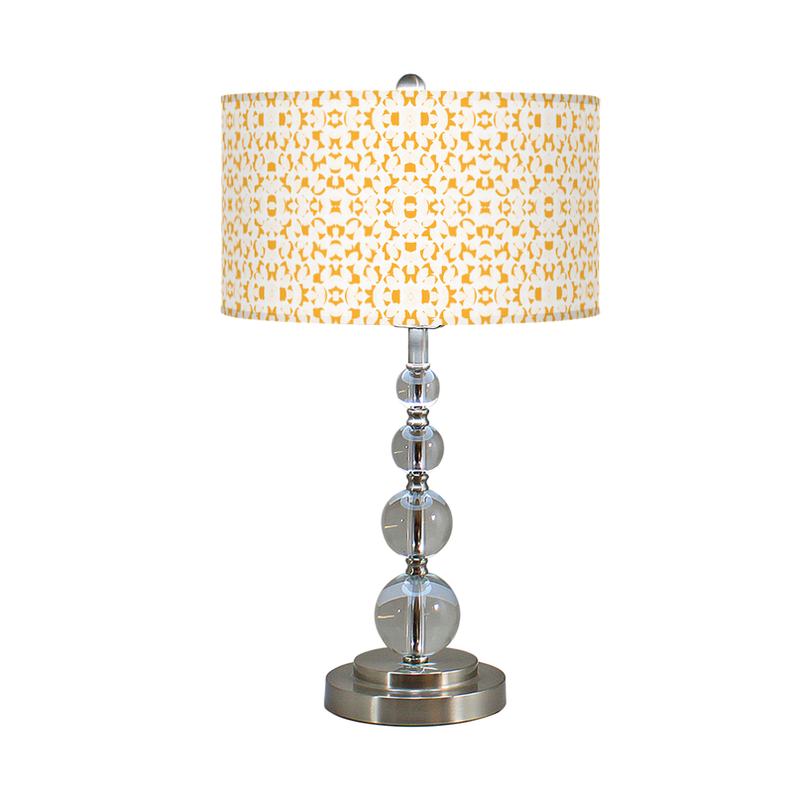 Table lamp with patterned drum shade and chrome stacked-globe base