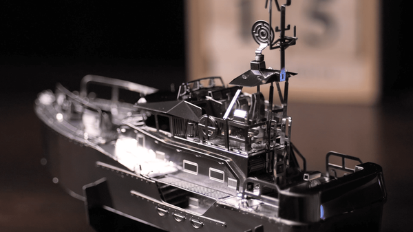 Miniature boat model with mast, radar-like detail, and deck equipment