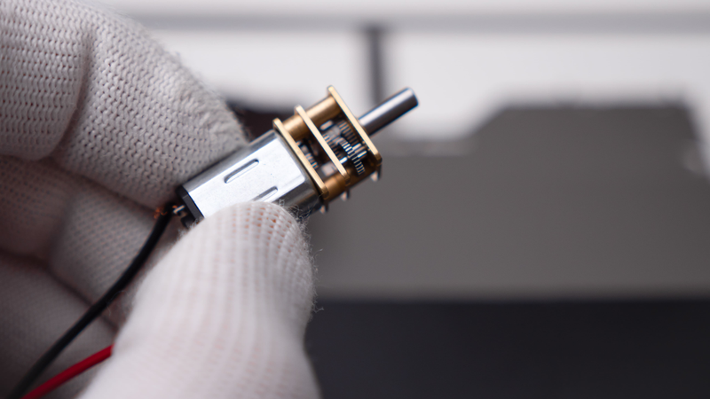 Boat model motor detail with cylindrical part and brass-colored connector