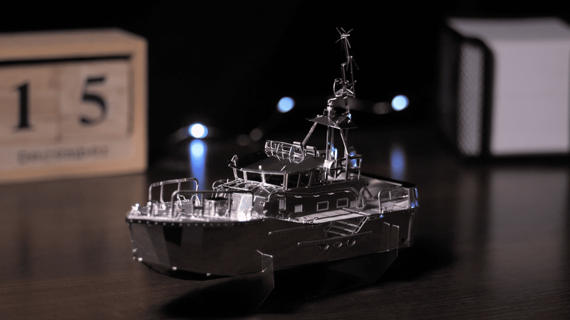 Miniature boat model with mast and layered deck equipment