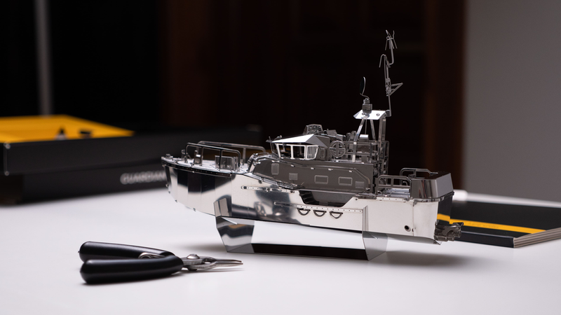 Detailed boat model with antennas and deck fixtures on display