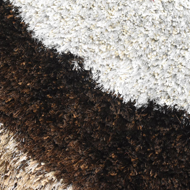 Two-tone shag area rug closeup with cream, brown, and dark fibers