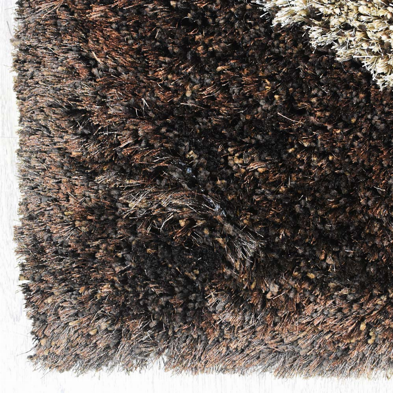 Shag area rug closeup with dark brown, black, and cream highlights