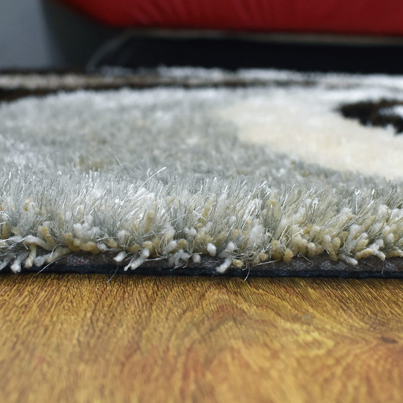 Close-up of shag rug pile texture in light gray and white with dark accents