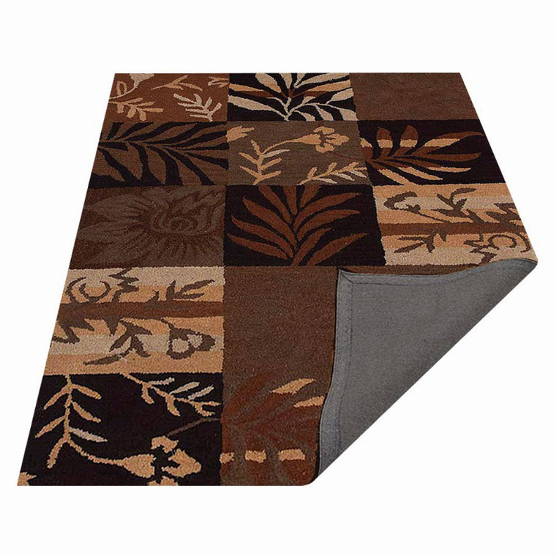 Corner view of patchwork floral area rug with botanical leaf motifs in brown and tan