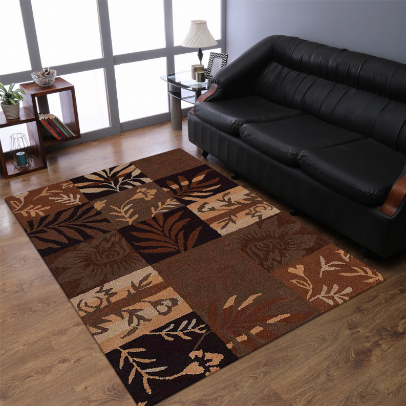 Angled view of floral patchwork area rug in brown and tan with leaf motifs
