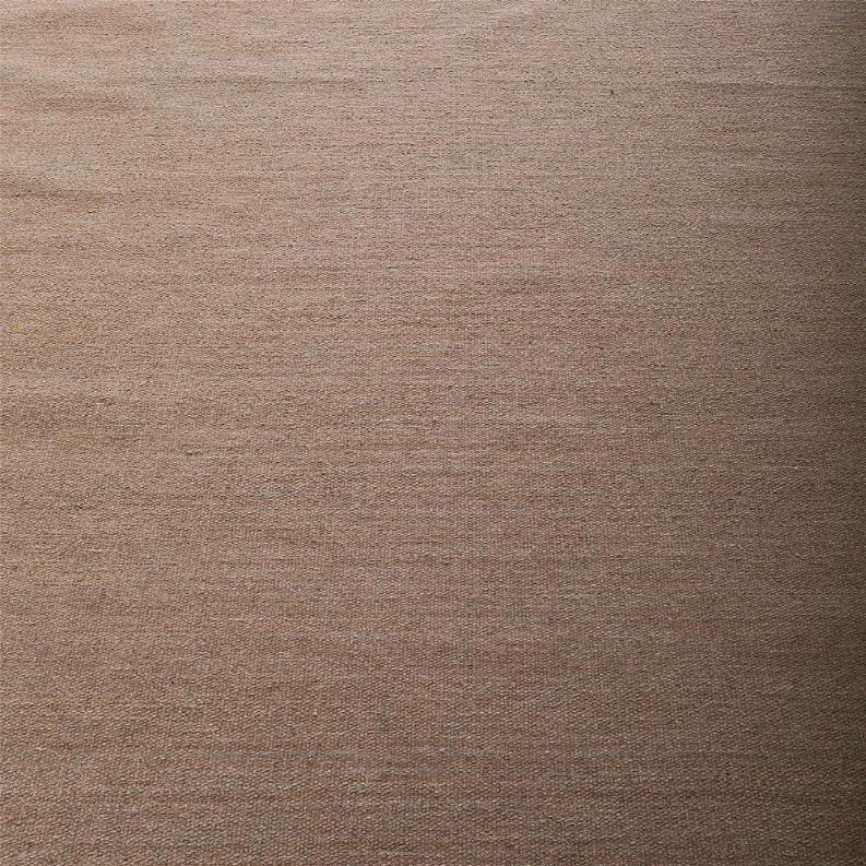 Close-up of tan flatweave Kilim wool rug texture and subtle tonal weave
