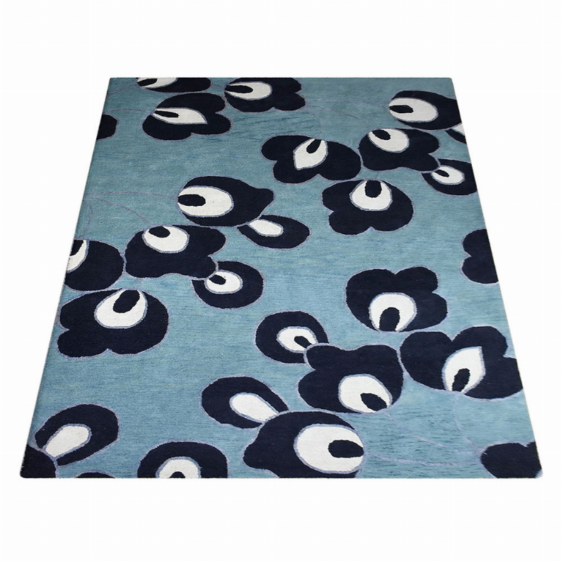 Blue floral area rug featuring dark navy flowers with white centers and outlines