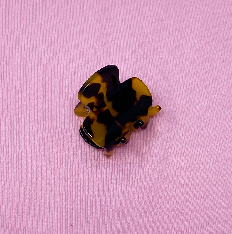 Mini hair claw clip with dark tortoiseshell pattern, metal teeth